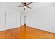 Hardwood floor bedroom with double doors and view of hallway at 3019 Parkstone Dr, Charlotte, NC 28210