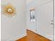 Bright entryway with hardwood floors and a sunburst mirror at 3019 Parkstone Dr, Charlotte, NC 28210