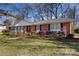 Ranch style brick home with a landscaped yard at 3019 Parkstone Dr, Charlotte, NC 28210