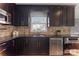 Modern kitchen featuring dark wood cabinets, granite countertops, and stainless steel appliances at 3019 Parkstone Dr, Charlotte, NC 28210