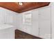 Laundry room with ample storage, wood ceiling and tile floor at 3019 Parkstone Dr, Charlotte, NC 28210