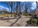 Large brick patio with stone retaining wall and seating area at 3019 Parkstone Dr, Charlotte, NC 28210