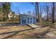 Blue storage shed with ramp access in backyard at 3019 Parkstone Dr, Charlotte, NC 28210