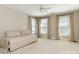 Spacious bedroom with a daybed, three windows, neutral color palette, and a ceiling fan at 3041 Valencia Ter, Charlotte, NC 28211