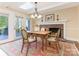 Cozy dining area with a brick fireplace, skylight, and access to an outdoor deck at 3041 Valencia Ter, Charlotte, NC 28211