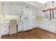 Bright kitchen featuring white cabinets, hardwood floors, and an adjacent desk area at 3041 Valencia Ter, Charlotte, NC 28211