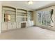 Sunlit living room features built-in shelving, cabinetry, and large windows at 3041 Valencia Ter, Charlotte, NC 28211