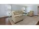 Comfortable living room with hardwood floors, neutral paint, and a large window for natural light at 3041 Valencia Ter, Charlotte, NC 28211