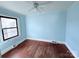 Light blue bedroom with hardwood floors and a window at 350 Turnersburg Hwy, Statesville, NC 28625