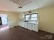 Small kitchen with white cabinets and a window above the sink at 350 Turnersburg Hwy, Statesville, NC 28625