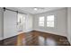 Bedroom with hardwood floors and barn door to en-suite bathroom at 400 E 27Th St, Kannapolis, NC 28083