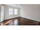 Hardwood floor bedroom with two windows and ceiling fan at 400 E 27Th St, Kannapolis, NC 28083