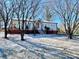 Snow-covered front yard of charming ranch home with brick accents and covered porch at 400 E 27Th St, Kannapolis, NC 28083