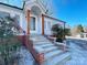 Steps leading to the front entrance of a renovated home with brickwork and wood columns at 400 E 27Th St, Kannapolis, NC 28083