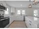 Modern white kitchen with stainless steel appliances and an island at 400 E 27Th St, Kannapolis, NC 28083