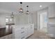 Modern kitchen island with white cabinets and quartz countertops at 400 E 27Th St, Kannapolis, NC 28083