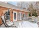 Brick home with deck, swing chairs, and winter scene at 4025 Weddington Manor Ct, Matthews, NC 28104