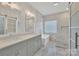 Elegant bathroom with double vanity, soaking tub and glass block window at 4025 Weddington Manor Ct, Matthews, NC 28104