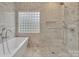 Spa-like bathroom with walk-in shower, soaking tub and marble tile at 4025 Weddington Manor Ct, Matthews, NC 28104