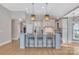 Modern kitchen with white cabinets and a large island at 4025 Weddington Manor Ct, Matthews, NC 28104