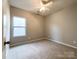 Simple bedroom with neutral carpet and window at 5052 Haven Lodge Rd, Matthews, NC 28104