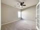 Well-lit bedroom with neutral carpet and large window at 5052 Haven Lodge Rd, Matthews, NC 28104