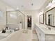 Bright bathroom featuring a soaking tub, glass shower, double vanity and a view into the walk-in closet at 5057 Spratt Rd, York, SC 29745