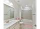 Bathroom with a tiled shower-tub combination, white vanity, and brushed nickel fixtures at 5057 Spratt Rd, York, SC 29745