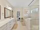 Bright bathroom featuring dual sinks, soaking tub and glass shower, perfect for relaxation at 5057 Spratt Rd, York, SC 29745