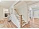 Inviting entryway with modern staircase, decorative table, and natural light, offering a warm welcome at 5057 Spratt Rd, York, SC 29745