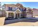 Impressive two-story home with a combination of stone and siding and a welcoming front porch at 5057 Spratt Rd, York, SC 29745