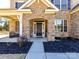 Inviting front door with stone archway and manicured landscaping at 5057 Spratt Rd, York, SC 29745