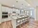 Open-concept kitchen featuring an island with seating, stainless steel appliances, and stylish pendants at 5057 Spratt Rd, York, SC 29745