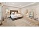 A beautifully furnished main bedroom features a tray ceiling, a stylish headboard and an ensuite bathroom at 5057 Spratt Rd, York, SC 29745