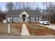 Gray house with a white trim, red shutters, and a walkway leading to the front door at 517 Grassy Creek Run, Chester, SC 29706