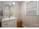 Bathroom featuring a vanity, mirror, and window for natural light at 523 Fence Post Ln, Matthews, NC 28105