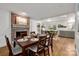 Dining area with a fireplace seamlessly connects to a modern kitchen with updated appliances and ample counter space at 523 Fence Post Ln, Matthews, NC 28105