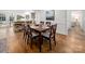 Dining area with hardwood floors leads to a bright kitchen and living space, perfect for entertaining guests at 523 Fence Post Ln, Matthews, NC 28105