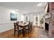 Bright dining room featuring a fireplace, hardwood floors, and windows at 523 Fence Post Ln, Matthews, NC 28105