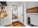 Entryway with open door to dining area, storage shelves, and coat hooks provide a welcoming and organized space at 523 Fence Post Ln, Matthews, NC 28105