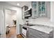 Bright kitchen featuring gray cabinetry, granite counters, stainless steel appliances, and hardwood floors at 523 Fence Post Ln, Matthews, NC 28105