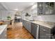 Bright kitchen featuring gray cabinetry, granite counters, stainless steel appliances, and wood floors at 523 Fence Post Ln, Matthews, NC 28105