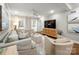 Comfortable living room featuring neutral decor, a large television, and ample seating at 523 Fence Post Ln, Matthews, NC 28105