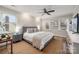 Relaxing main bedroom with a ceiling fan, natural light from windows, and neutral tones create a peaceful retreat at 523 Fence Post Ln, Matthews, NC 28105