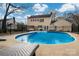 Backyard featuring a large in-ground swimming pool with lounge chairs and a black metal fence at 523 Fence Post Ln, Matthews, NC 28105