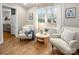 Bright sitting room featuring comfortable armchairs, hardwood flooring, and a view of the pool at 523 Fence Post Ln, Matthews, NC 28105