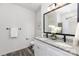 Modern bathroom with granite countertops, double sinks, and a frameless mirror at 6325 Rockwell W Blvd, Charlotte, NC 28269