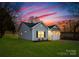 Newly built home with gray siding, a two-car garage, and a well-manicured lawn at 6325 Rockwell W Blvd, Charlotte, NC 28269