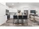 Modern kitchen with white cabinets, granite counters, and an island with seating at 6325 Rockwell W Blvd, Charlotte, NC 28269