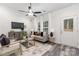 Living room with grey sofa and a view to the backyard at 6325 Rockwell W Blvd, Charlotte, NC 28269